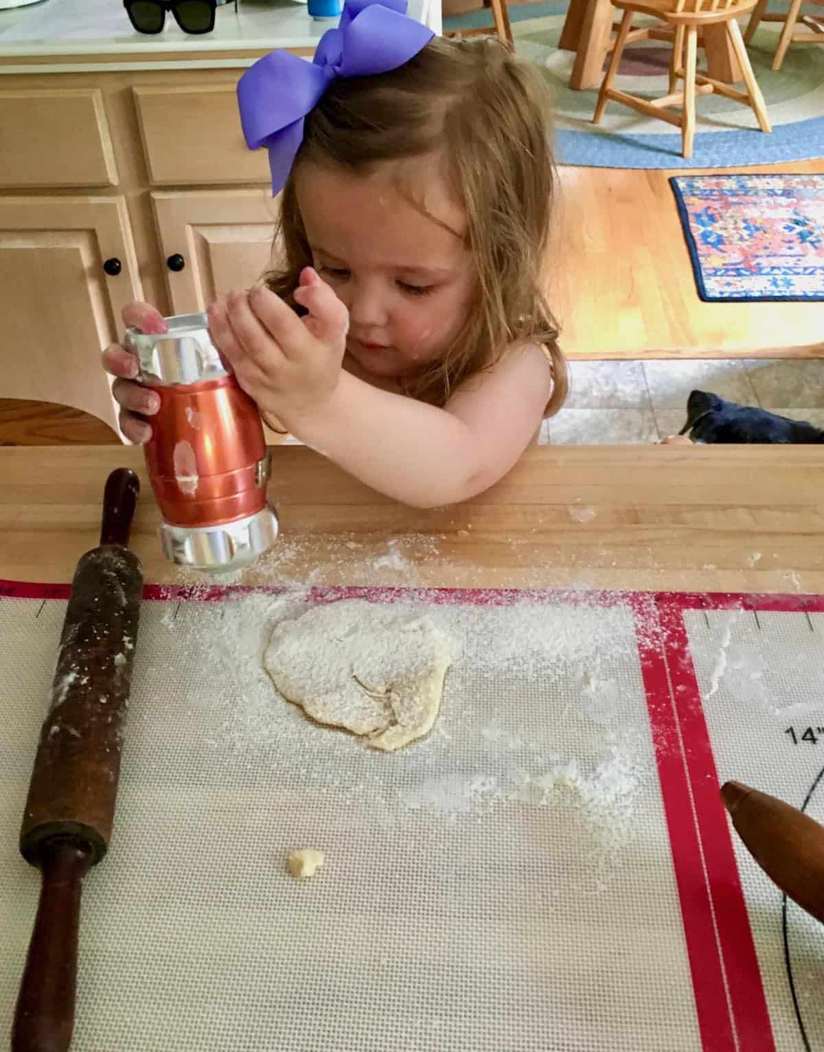 grand daughter rolling pie dough