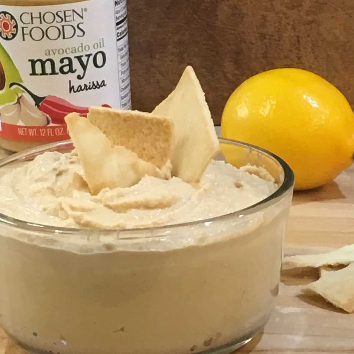 hummus with lemon and chips with product jar