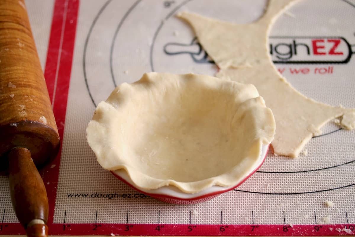 rolling pie dough into pie plate