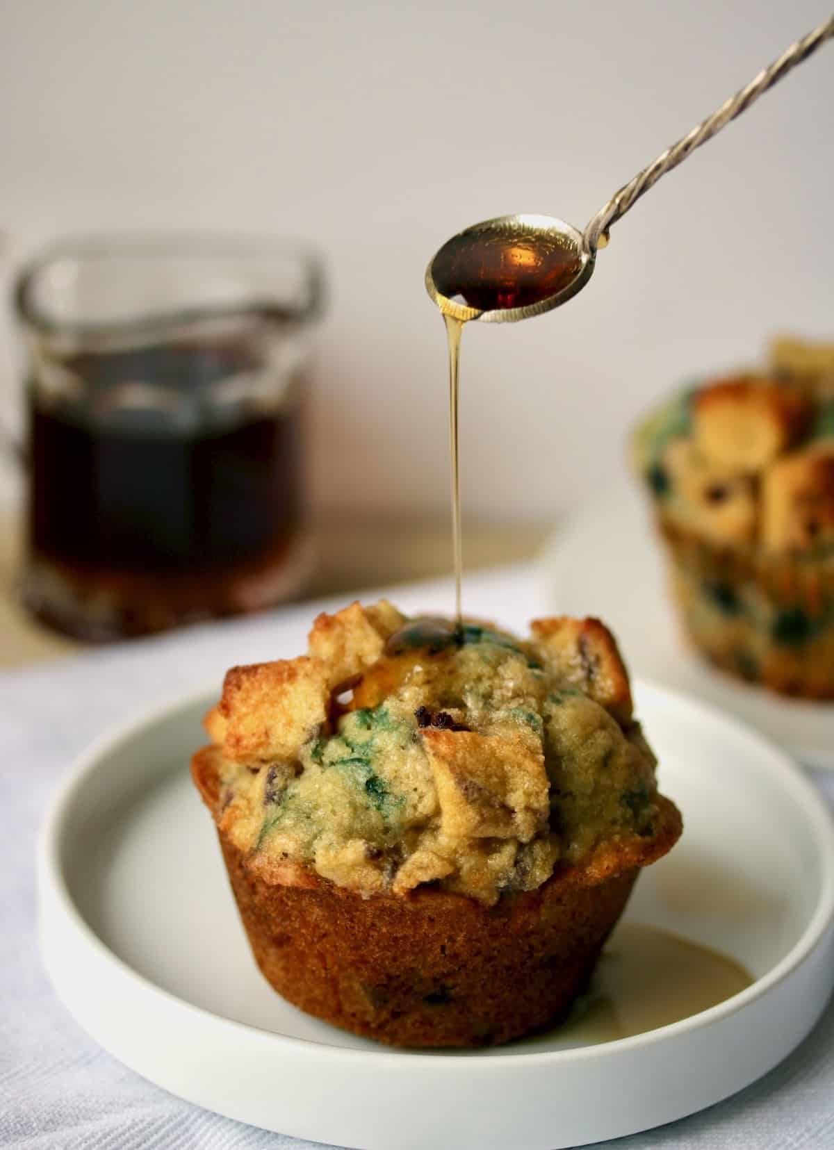 cut muffin with maple syrup