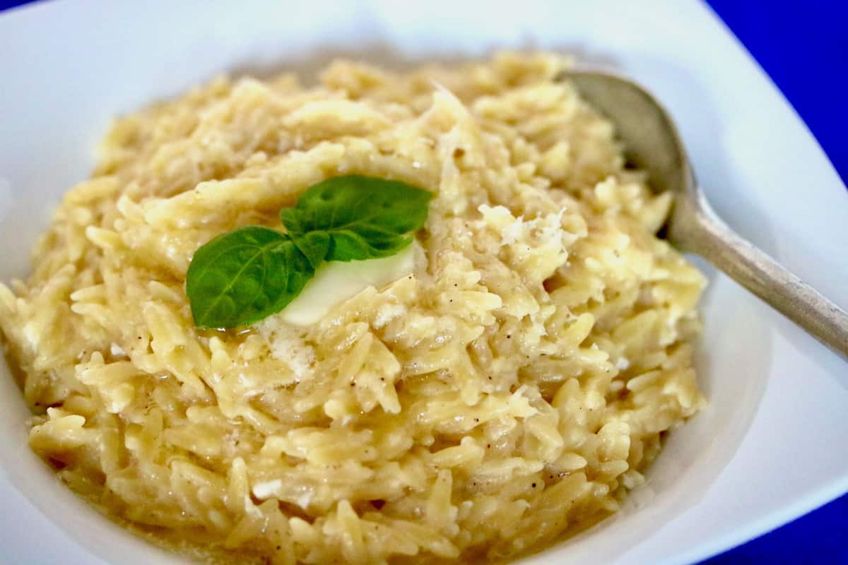 bowl of pastina topped with butter and basil